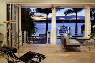 Example of a mid-sized trendy open concept porcelain tile living room design in Tampa with green walls and no fireplace