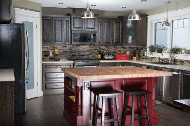 Kitchen - large farmhouse u-shaped medium tone wood floor and gray floor kitchen idea in Other with a drop-in sink, raised-panel cabinets, brown cabinets, wood countertops, brown backsplash, glass tile backsplash, stainless steel appliances and an island