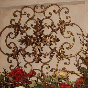 gold and silver leafed iron piece mounted on fireplace