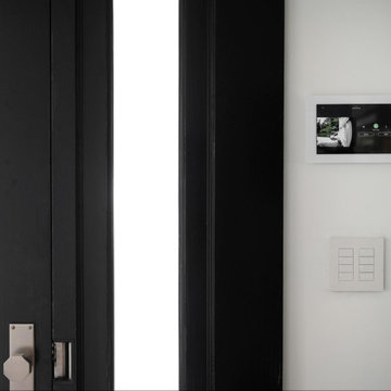 Security cameras and lighting keypads highlight the front door entryway