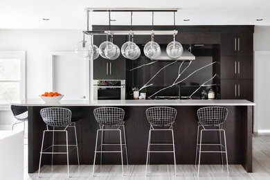 Inspiration for a large contemporary porcelain tile and gray floor enclosed kitchen remodel in New Orleans with an undermount sink, flat-panel cabinets, dark wood cabinets, quartzite countertops, black backsplash, marble backsplash, stainless steel appliances, an island and white countertops