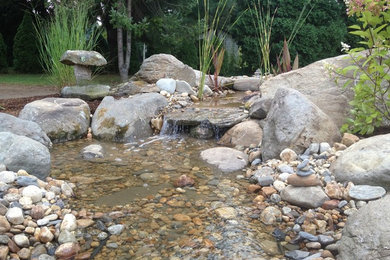 Design ideas for a mid-sized traditional partial sun backyard gravel landscaping in Providence for summer.