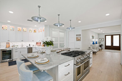 Kitchen - large coastal kitchen idea in Other with beaded inset cabinets, white cabinets, white backsplash, subway tile backsplash, stainless steel appliances and an island