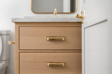 Inspiration for a small modern mosaic tile floor and beige floor powder room remodel in Los Angeles with flat-panel cabinets, light wood cabinets, white walls, an undermount sink, quartz countertops, beige countertops and a freestanding vanity