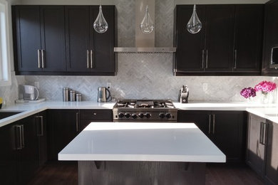 Inspiration for a mid-sized contemporary u-shaped dark wood floor and brown floor eat-in kitchen remodel in Toronto with a single-bowl sink, shaker cabinets, dark wood cabinets, quartz countertops, white backsplash, marble backsplash, stainless steel appliances and an island