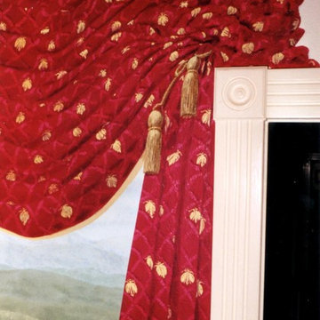 Trompe l'oeil mural with painted drapery that matches actual drapery in the room