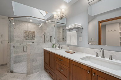 Example of a white tile and marble tile marble floor, white floor and double-sink bathroom design in Seattle with shaker cabinets, medium tone wood cabinets, an undermount sink, quartz countertops, a hinged shower door, white countertops and a built-in vanity