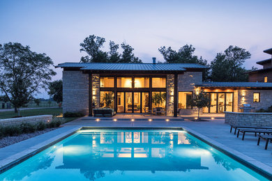 Inspiration for a huge rustic beige one-story stone exterior home remodel in Wichita with a metal roof