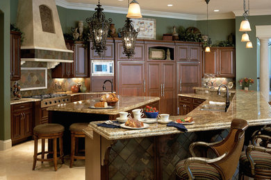 Eat-in kitchen - large traditional u-shaped travertine floor eat-in kitchen idea in Detroit with an undermount sink, raised-panel cabinets, dark wood cabinets, granite countertops, green backsplash, stainless steel appliances and an island