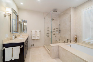 Corner shower - large transitional master beige tile and stone slab marble floor corner shower idea in Chicago with an undermount sink, raised-panel cabinets, dark wood cabinets, marble countertops, an undermount tub and beige walls
