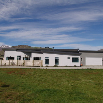 Side view of the dwelling with guest wing to right of the garage
