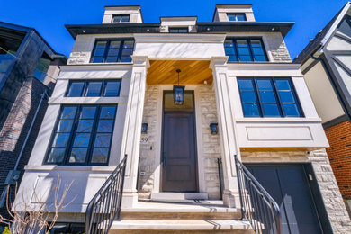 Design ideas for a large transitional two-storey beige house exterior in Toronto with mixed siding, a hip roof and a shingle roof.