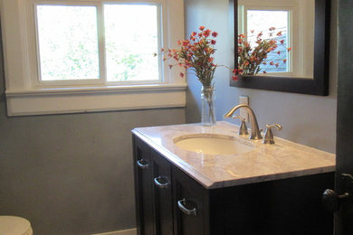 Inspiration for a small craftsman master beige tile and porcelain tile porcelain tile tub/shower combo remodel in Other with flat-panel cabinets, dark wood cabinets, a one-piece toilet, gray walls, an undermount sink and granite countertops