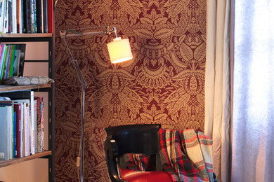 Immagine di un soggiorno chic aperto con libreria, pareti rosse e parquet chiaro