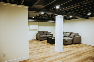 Mid-sized trendy underground vinyl floor and brown floor basement photo in Other with yellow walls and no fireplace
