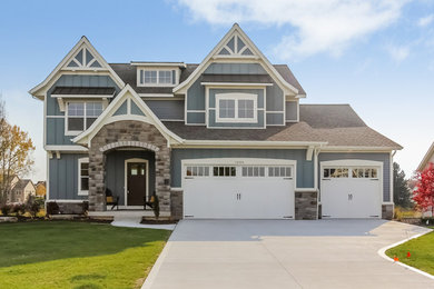 Inspiration for a large craftsman gray two-story wood gable roof remodel in Grand Rapids