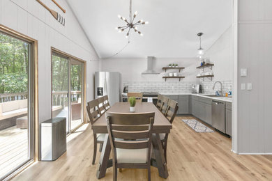 Example of a mid-sized minimalist vinyl floor and brown floor dining room design in Other with gray walls and no fireplace