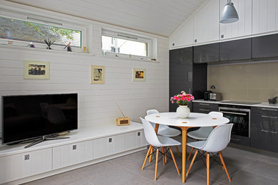 Small contemporary open plan dining room in London with white walls, porcelain flooring and no fireplace.