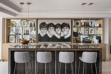 Trendy galley beige floor seated home bar photo in Miami with flat-panel cabinets, light wood cabinets, wood countertops, mirror backsplash and beige countertops