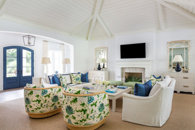 Example of an island style medium tone wood floor, brown floor, shiplap ceiling and vaulted ceiling living room design in Miami with white walls, a standard fireplace, a stone fireplace and a wall-mounted tv