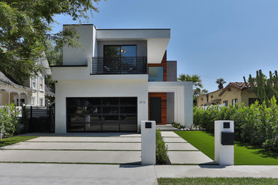 Large modern two-storey stucco white house exterior in Los Angeles with a flat roof, a mixed roof and a black roof.