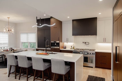 Kitchen - contemporary gray floor kitchen idea in Cincinnati with flat-panel cabinets, dark wood cabinets, quartz countertops, white backsplash, quartz backsplash, stainless steel appliances and white countertops