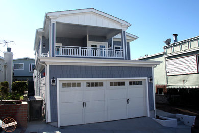 Large modern two-storey blue exterior in Los Angeles with a gable roof and vinyl siding.