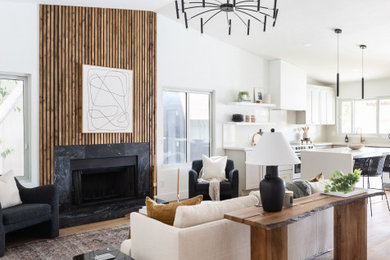 Inspiration for a small modern open concept laminate floor, brown floor, vaulted ceiling and wood wall living room remodel in Phoenix with a standard fireplace