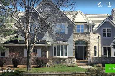 Inspiration for a large transitional gray three-story stucco gable roof remodel with a tile roof and a gray roof