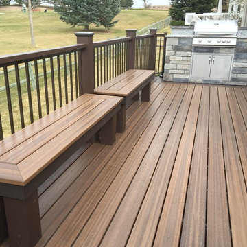 Large Evergrain Envisions deck with Fireplace and built in grill