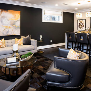 This is an example of a medium sized look-out basement in DC Metro with blue walls, dark hardwood flooring and black floors.