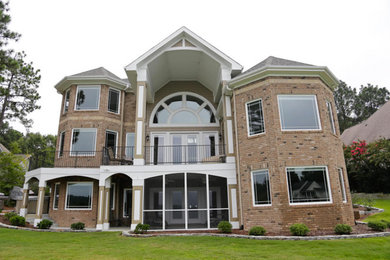 Example of a large classic two-story brick exterior home design in Raleigh