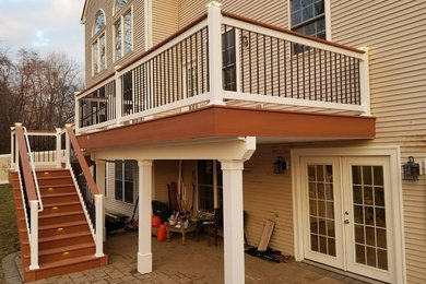 Example of a mid-sized trendy backyard deck design in Philadelphia with no cover