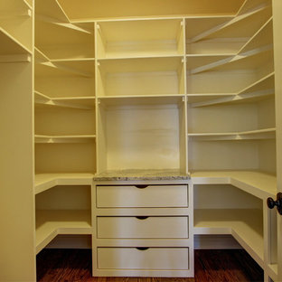 Mid-sized mediterranean kitchen pantry designs - Mid-sized tuscan medium tone wood floor kitchen pantry photo in Denver with a farmhouse sink, recessed-panel cabinets, dark wood cabinets, granite countertops, white backsplash, subway tile backsplash, stainless steel appliances and an island