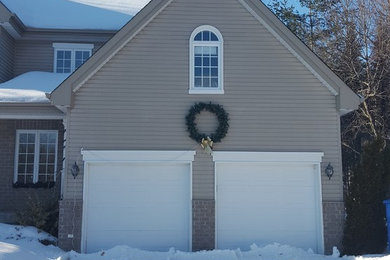 Garage - mid-sized traditional attached two-car garage idea in Montreal