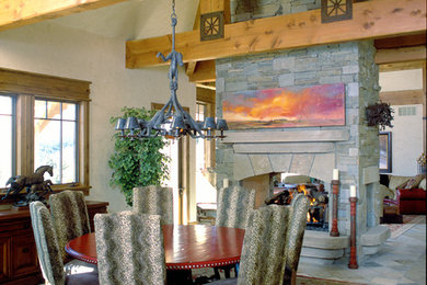 Design ideas for a large country separate dining room in Denver with beige walls, a two-sided fireplace, a stone fireplace surround and multi-coloured floor.