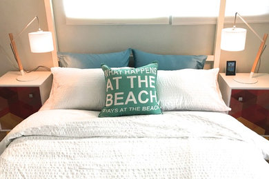 Example of a small beach style guest gray floor bedroom design in New York with green walls