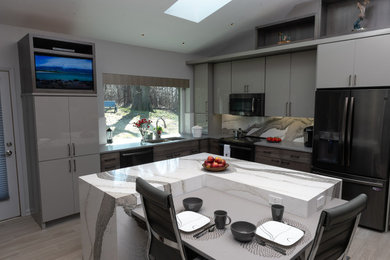 Enclosed kitchen - mid-sized modern l-shaped porcelain tile and gray floor enclosed kitchen idea in Chicago with a double-bowl sink, flat-panel cabinets, gray cabinets, quartz countertops, gray backsplash, quartz backsplash, black appliances, an island and multicolored countertops