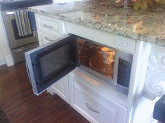 Does anyone regret installing your microwave in your kitchen ... - I put the extra money saved elsewhere. I am really happy with the microwave  in the island, it is out of sight and does the job.