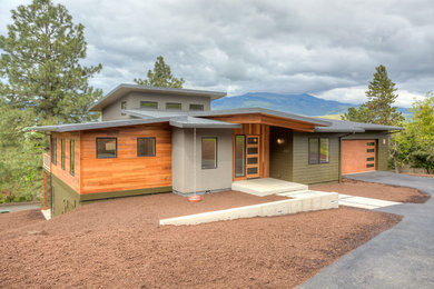 Large minimalist multicolored two-story mixed siding house exterior photo in Other with a shed roof and a metal roof