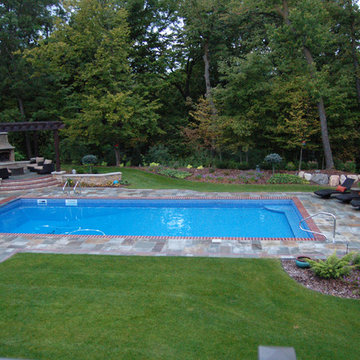 Bluestone pool decks, arbors, fireplaces, outdoor kitchen under pavilion