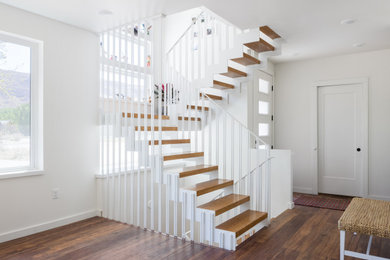 Example of a mid-sized eclectic wooden u-shaped open and metal railing staircase design in Other