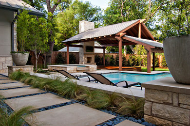 Inspiration for a contemporary backyard pool in Dallas.