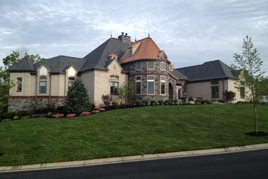 Example of a large minimalist brown three-story wood exterior home design in Cincinnati