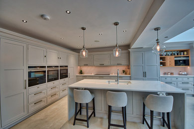Design ideas for a classic kitchen in London with black appliances and an island.