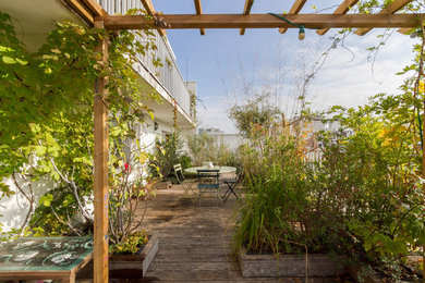 This is an example of a mid-sized contemporary rooftop deck in Paris with a container garden and no cover.