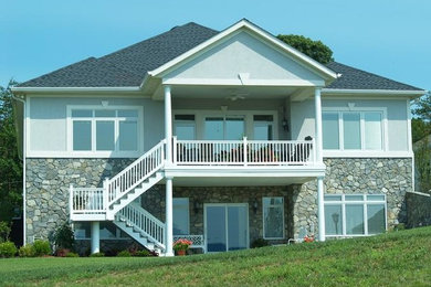 Inspiration for a large gray two-story stone exterior home remodel in Other