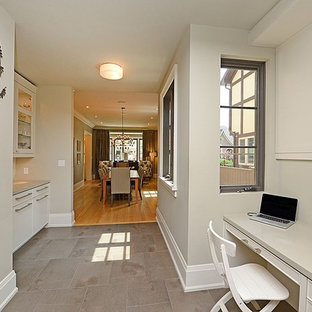 This is an example of a medium sized modern study in Toronto with grey walls, slate flooring, a built-in desk and no fireplace.