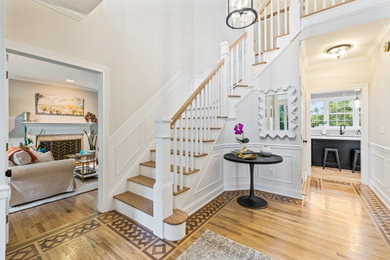 Example of a minimalist wooden curved wood railing staircase design in Baltimore with painted risers