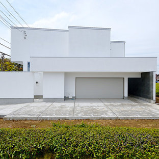 東京都下のモダンスタイルのおしゃれな家の外観 (戸建、漆喰サイディング、片流れ屋根、金属屋根) の写真